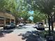 Street view of a shopping center with shops, parked cars, and trees at 721 Governor Morrison St, Charlotte, NC 28211