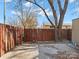 Backyard with wooden fence, concrete patio, and large tree at 7530 Holly Grove Ct, Charlotte, NC 28227