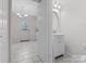 Small bathroom with white vanity and decorative mirror at 7530 Holly Grove Ct, Charlotte, NC 28227