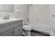 Clean bathroom with a bathtub and gray vanity at 7530 Holly Grove Ct, Charlotte, NC 28227