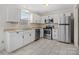 Kitchen with white cabinets and stainless steel appliances at 7530 Holly Grove Ct, Charlotte, NC 28227