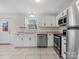 Updated kitchen featuring stainless steel appliances and white cabinetry at 7530 Holly Grove Ct, Charlotte, NC 28227