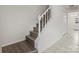 Modern stairs with white railing and wood steps at 7530 Holly Grove Ct, Charlotte, NC 28227