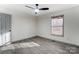 A bedroom with wood-look flooring, ceiling fan, and neutral colors at 776 Washington Ln, Kannapolis, NC 28083