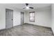 Large empty room features white walls, wood floors, ceiling fan and gray doors and trim at 776 Washington Ln, Kannapolis, NC 28083