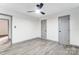 Large empty room features white walls, wood floors, ceiling fan and gray doors and trim at 776 Washington Ln, Kannapolis, NC 28083