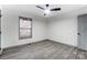 This bedroom is bright with wood-look floors, a ceiling fan and grey doors and window trim at 776 Washington Ln, Kannapolis, NC 28083