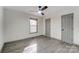 This bedroom features wood-look flooring, a ceiling fan, and two neutral-colored doors at 776 Washington Ln, Kannapolis, NC 28083