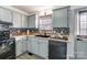 Cozy kitchen featuring light cabinets, black appliances, butcher block counters, and decorative tile backsplash at 776 Washington Ln, Kannapolis, NC 28083