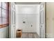 A view of the pantry with white walls, wood-look floors, and a single light at 776 Washington Ln, Kannapolis, NC 28083