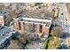 Aerial view of brick apartment building featuring visible parking and a view of the surrounding neighborhood at 780 N Davidson St, Charlotte, NC 28202