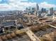 An aerial view of Spectrum Center and downtown buildings in a sunny cityscape at 780 N Davidson St, Charlotte, NC 28202