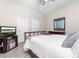 Comfortable bedroom with white bedding, a ceiling fan, a TV, and neutral walls at 780 N Davidson St, Charlotte, NC 28202