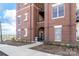 Brick apartment building exterior with an arched entrance, walkway, and well-maintained landscaping at 780 N Davidson St, Charlotte, NC 28202