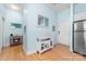 A bright entryway with hardwood floors, a white storage cabinet and a mirror on the wall at 780 N Davidson St, Charlotte, NC 28202