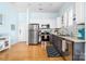 Open kitchen area with stainless steel appliances, light countertops, tile backsplash and hardwood floors at 780 N Davidson St, Charlotte, NC 28202