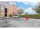 A well-maintained parking lot in front of a brick apartment building on a sunny day at 780 N Davidson St, Charlotte, NC 28202