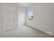 Simple bedroom with neutral carpeting and a large window at 8048 Plymouth Rd, Sherrills Ford, NC 28673