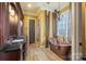 Luxurious bathroom with copper tub and double vanity at 8128 Bayview Ln, Belmont, NC 28012