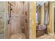 Large walk-in shower with tile surround and built-in shelving at 8128 Bayview Ln, Belmont, NC 28012