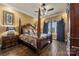 Spacious bedroom with a large four poster bed and hardwood floors at 8128 Bayview Ln, Belmont, NC 28012