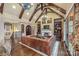 Grand living room with hardwood floors, exposed beams, and a fireplace at 8128 Bayview Ln, Belmont, NC 28012