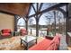 Relaxing covered porch overlooking the lake with wicker furniture at 8128 Bayview Ln, Belmont, NC 28012