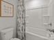 The bathroom is a tub and toilet combo with a shower curtain, framed print, and tile walls at 820 Regulus Ct, York, SC 29745