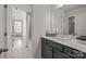 This bathroom showcases modern finishes, a gray vanity, a white countertop, and access to the bedroom at 820 Regulus Ct, York, SC 29745