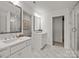 Bright bathroom features double sinks, quartz countertop vanity, walk-in shower, and white marble-look tile flooring at 820 Regulus Ct, York, SC 29745