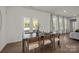 Bright dining area with a dark wood table, seating for six, and a glass door leading to a patio at 820 Regulus Ct, York, SC 29745