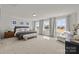 This is a large main bedroom with neutral carpet, lots of light, and modern decor at 820 Regulus Ct, York, SC 29745