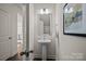 Stylish powder room with pedestal sink, framed mirror, and decorative wall art at 820 Regulus Ct, York, SC 29745