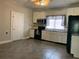 Updated kitchen with white cabinets and tile floors at 907 Sioux St, Monroe, NC 28110