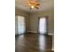 Living room with hardwood floors and window curtains at 907 Sioux St, Monroe, NC 28110