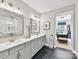 Bright bathroom featuring dual vanities, black tile floors, and a walk-in glass shower at 9730 Briarwick Ln, Charlotte, NC 28277