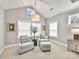 Bedroom sitting area features accent chairs, a small table, natural lighting, and decorative pillows at 9730 Briarwick Ln, Charlotte, NC 28277