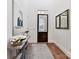 Bright entryway featuring hardwood floors, a console table with floral arrangements, and a decorative mirror at 9730 Briarwick Ln, Charlotte, NC 28277