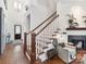 Beautiful entryway featuring hardwood floors, staircase with decorative spindles, and fireplace at 9730 Briarwick Ln, Charlotte, NC 28277