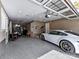 Well-organized garage featuring a high-end sports car, epoxy floors, and storage solutions at 9730 Briarwick Ln, Charlotte, NC 28277