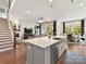 Modern kitchen with an island flowing into the living and dining area in an open-concept design at 9730 Briarwick Ln, Charlotte, NC 28277