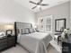 Serene main bedroom featuring shiplap accent wall, plush bedding, and natural light from shuttered windows at 9730 Briarwick Ln, Charlotte, NC 28277