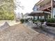 Spacious outdoor patio with fireplace, dining set and stone pavers offers an elegant space for entertaining at 9730 Briarwick Ln, Charlotte, NC 28277