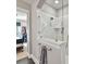 Modern bathroom featuring a glass-enclosed shower with sleek fixtures and marble-style tile surround at 9730 Briarwick Ln, Charlotte, NC 28277