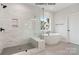 Luxurious bathroom boasts a marble tile shower, soaking tub, and matte black fixtures at 1008 Marquis Hills Dr # Mas0106, Fort Mill, SC 29715