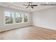 Bright bedroom featuring hardwood floors, a ceiling fan, and large windows offering views of the outdoors at 1008 Marquis Hills Dr # Mas0106, Fort Mill, SC 29715