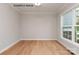 Empty room featuring hardwood floors and a large window providing natural light at 1008 Marquis Hills Dr # Mas0106, Fort Mill, SC 29715