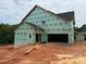 Home under construction with visible framing and GreenGuard, including a ladder up to a garage at 1008 Marquis Hills Dr # Mas0106, Fort Mill, SC 29715
