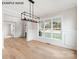 Elegant dining area with panel molding, hardwood floors, a modern light fixture, and large windows at 1008 Marquis Hills Dr # Mas0106, Fort Mill, SC 29715