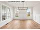 Bright dining area featuring hardwood floors, large windows, and stylish modern lighting at 1008 Marquis Hills Dr # Mas0106, Fort Mill, SC 29715